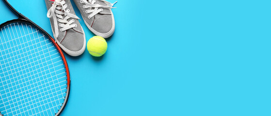 Tennis racket, shoes and ball on blue background with space for text