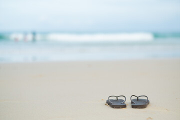 shoes on the sand with sea background, relax background , nice ocean