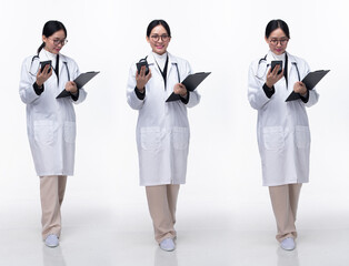 Full length 30s 40s Asian Woman Doctor with stethoscope, walking forward left right, wear formal Coat pant shoes. Smile Hospital female carry Patient Chart phone over white background isolated