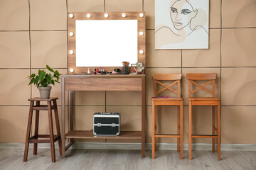 Interior of room with modern makeup artist's workplace near color wall