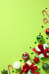 Christmas vertical light green background with gift boxes, candy canes, red and green baubles,...