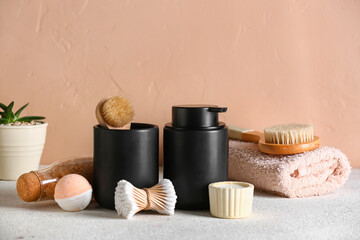Fototapeta na wymiar Set of bath supplies on table near color wall