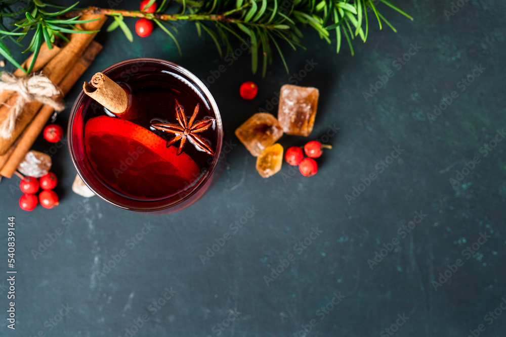 Wall mural gluhwein sweet hot warm mulled red wine or punch tea in mug cup glass spices citrus aromatic cinnamo