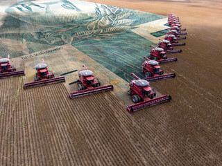 Mass soybean harvesting at a farm in Mato Grosso state,Brazil. Concept brazilian real bank note...