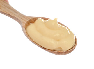 Wooden spoon of tasty vanilla pudding on white background, closeup