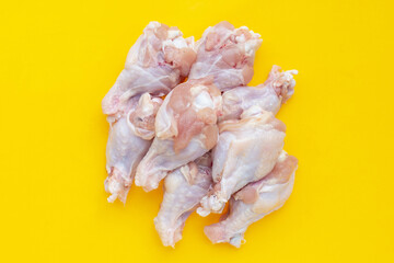 Fresh raw chicken wings (wingstick) on yellow background.