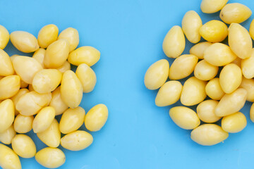 Boiled ginkgo nuts on blue background.