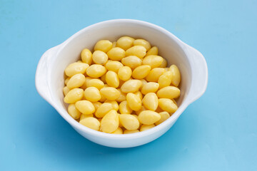 Boiled ginkgo nuts on blue background.