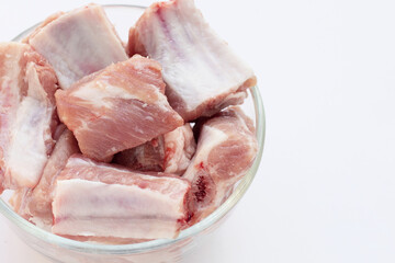 Raw pork ribs in glass bowl