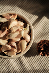 Garlic Bulb under morning sunlight on brown background. Autumn and winter tone. Concept of spices for healthy cooking.	

