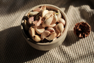 Garlic Bulb under morning sunlight on brown background. Autumn and winter tone. Concept of spices for healthy cooking.	
