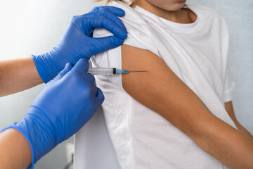 vaccination of children, a little boy at a doctor's appointment, an injection in the arm, children's medicine, an injection in the arm
