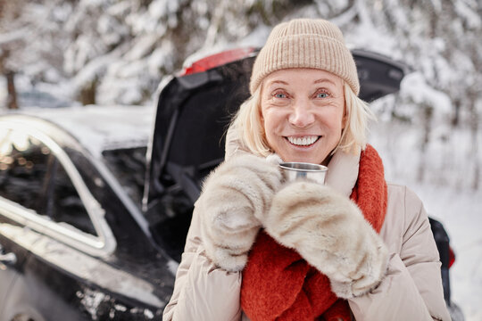 Portrait Of Smiling Mature Woman Enjoying Cup Of Hot Coco Outdoors In Winter And Looking At Camera, Copy Space