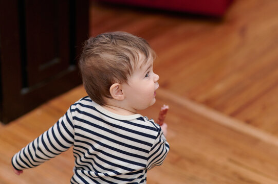 Cute Toddler Running Away With A Sausage In Hand