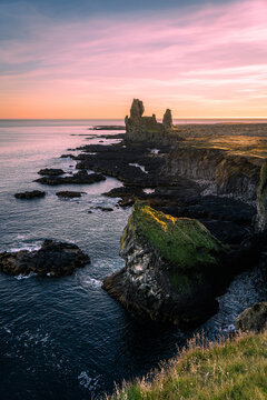 verticle view of Arnarstapi Cliff under colorful sunset