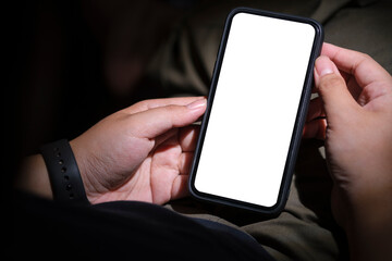 Close up view of man hands holding mobile phone. White empty screen for out advertise text.