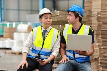 Fototapeta premium Group of technician engineer and businessman in protective uniform standing and discussing, researching, brainstorming and planning work together with tablet at industry manufacturing factory