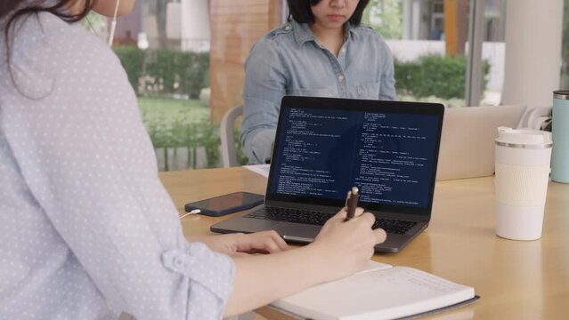 Digital transformation future workforce. Asia people young talent woman busy talk phone call work at hybrid office reskill upskill martech remote job write code on AI cyber security cloud computing.