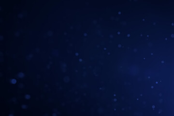 A dark blue background bokeh image for used to decorate background.