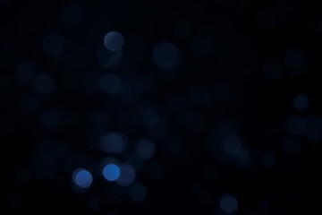 A dark blue background bokeh image for used to decorate background.