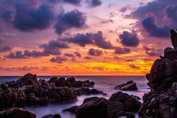 sunset on the beach, big rocks and sky full of colors, clouds in the sky and waves on the sea, puerto escondido oaxaca 