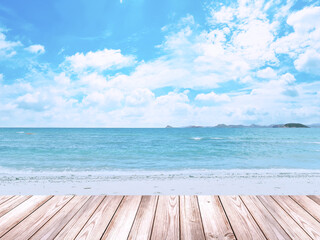 Empty wooden table for displaying products. The background is sea view blue sky and white clouds.
(with copy )
