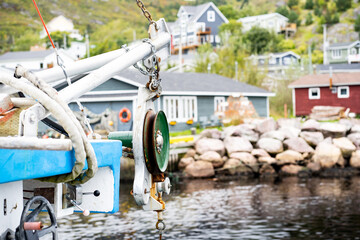 Fototapeta na wymiar A pulley used for winching lobster traps and crab traps on a fishing boat while docked at a pier in Petty Harbour Newfoundland Canada.