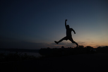 silhouette of a man jumping