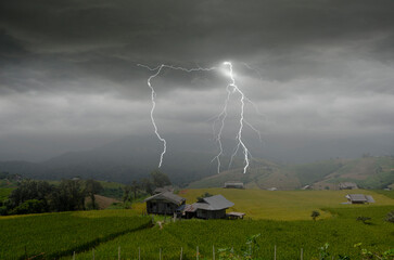 Dangerous lightning and thunder storm cover rice field on the hill