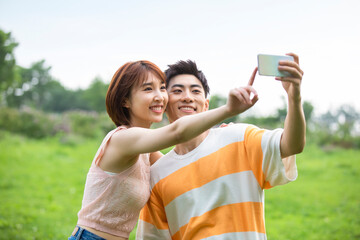 Happy young couple taking selfie with smartphone