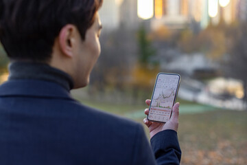 Businessman checking stock market data on smartphone