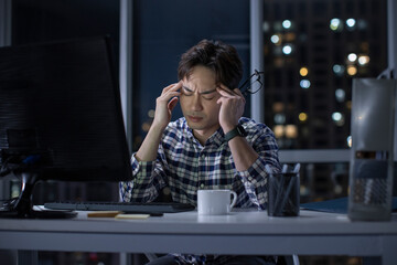 IT worker working in office at night