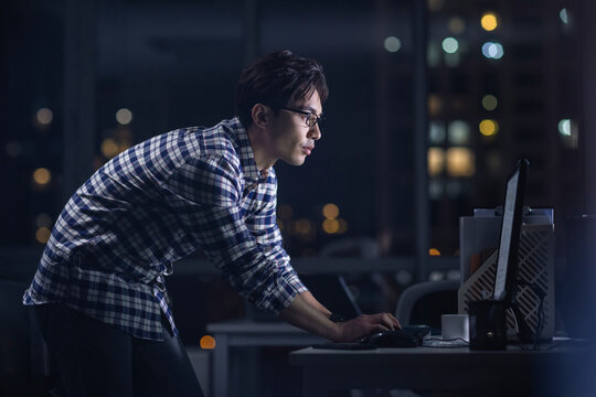 IT worker working in office at night