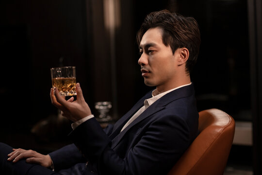 Elegant man drinking whiskey
