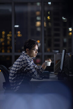 IT worker working in office at night