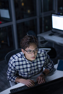 IT worker working in office at night