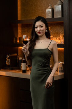 Beautiful young woman drinking red wine