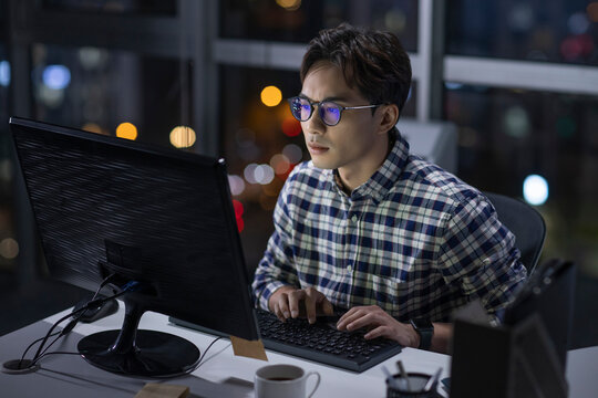 IT worker working in office at night