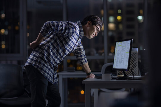 IT worker working in office at night