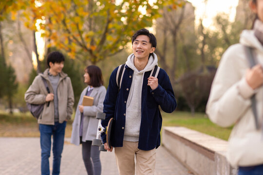 Happy college students walking on campus