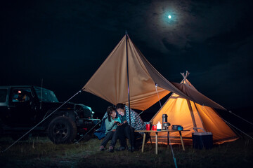 Happy couple camping outdoors