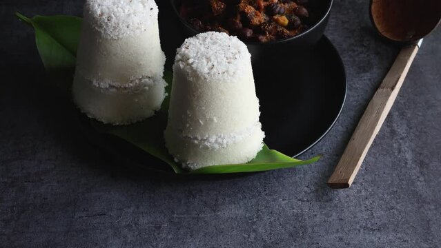 Rice Puttu white Pittu , Kadala Chickpea curry , milk tea , popular South Indian breakfast steamed rice cake Kerala food Tamil Nadu India Sri Lanka. rice flour grated coconut 4k video footage