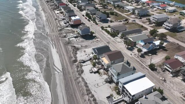Clean up after Hurricane Ian storm surge causes beach erosion and damages property at Surfside Garden City along coastal South Carolina