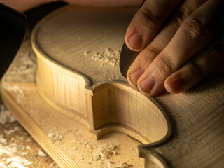 violin artisan maker hand smooth surfaces with scraper to desired plate thickness