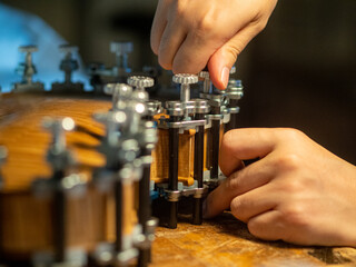 maker artisan clamping violin back to ribs using glue and locating pins