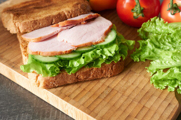 A close-up of a meat and greens sandwich. A photo of a mouthwatering meal.