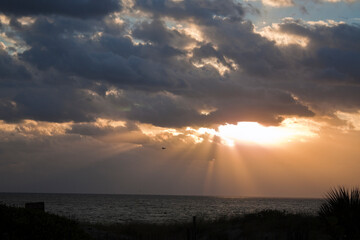 Beautiful sunrise with god rays on a beach in Florida, USA.