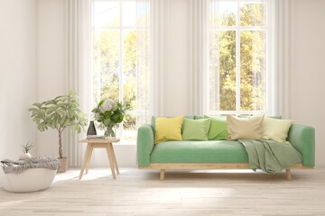 Fototapeta premium Stylish room in white color with sofa and autumn landscape in window. Scandinavian interior design. 3D illustration