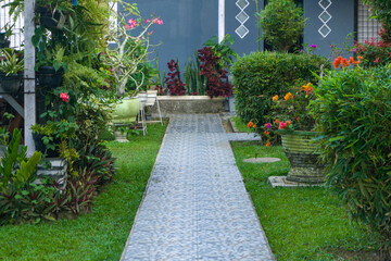 walkway or pathway for walk to connecting each section of the building. passageway or footpath with flowers and plants around