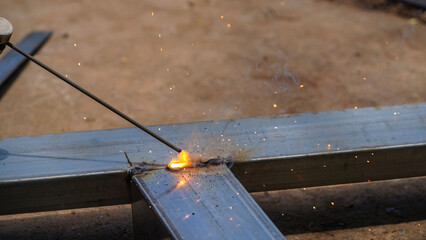 Iron soldering, Man working on iron soldering, welding sparks